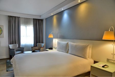hotel room with bed and coffee table with chairs